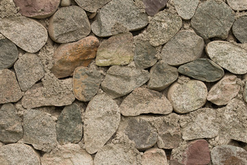 Texture of thick and strong wall of rough stones of various shapes. Stone wall background. 