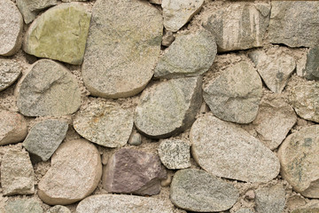  Texture of thick and strong wall of rough stones of various shapes. Stone wall background. 