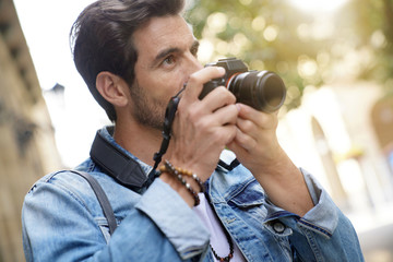 Photographer taking pictures in European city