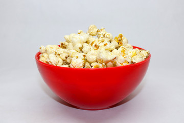 Popcorn in red with caramel on white background