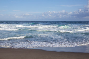 beautiful blue ocean and black sand beach on the Azores, in Portugal