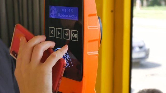 CloseUp of Paying by a telephone using Paypass Reader on a Ticket Vending Machine with Terminal. Ukraina Kiev.