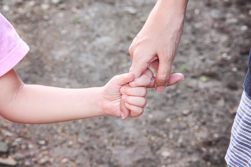 Asian mother and her daughter holding hands