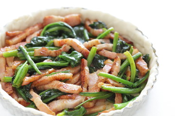 bacon and spinach stir fried in pie dough for quiche cooking