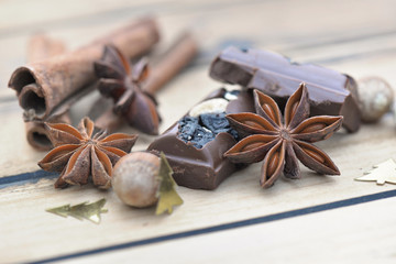 close on star anise with chocolat and cinnamon on wooden background