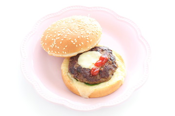 Homemade patty burger on dish for comfort food image