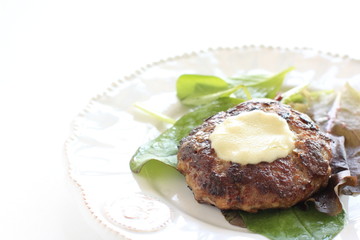 Cheese burger on baby leaf vegetable salad