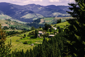 Naklejka premium Mountain village landscape in the wild Ukrainian Bukovyna area