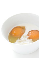 raw egg and milk in bowl for cooking image