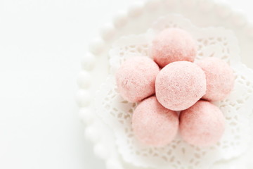 home bakery, pink cookie ball on white dish 