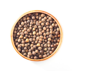 Allspice (Jamaica pepper) in wooden cup on the white background