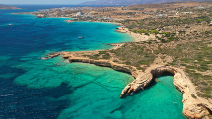 Aerial drone photo of paradise rocky seascape forming caves with turquoise clear sea near popular beaches of Pori and Italida, Koufonisi island, Cyclades, Greece
