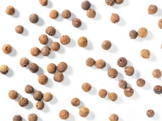 Allspice (Jamaica pepper) on white background. Macro photo