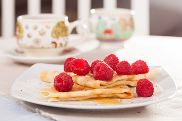 delicious  pancakes with fresh raspberries and honey