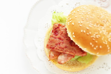 Pan fried luncheon meat and sausage in sesame bun for sandwich breakfast