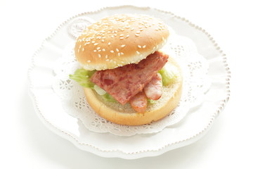 Pan fried luncheon meat and sausage in sesame bun for sandwich breakfast