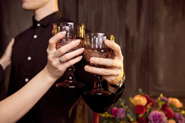 Young people dressed as vampires drinking cocktails at Halloween party