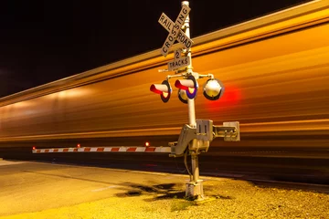 Poster train passes a crailway crossing by night at route 66 © travelview