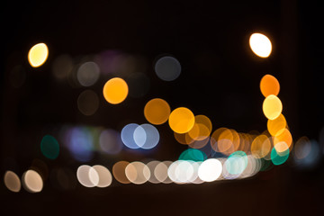 Night city street lights bokeh background. Colored circles from glowing objects.