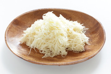 Shaved potato on wooden plate for prepared food