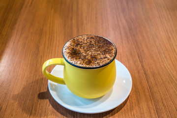 Cup of coffee on wooden table, top view. Coffee cup top view on wooden table background