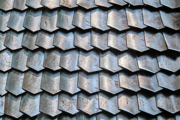 Texture of ancient Roman armor plates, Lorica. Background of rusty chain mail armor from connected...