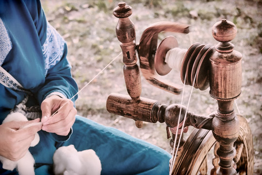 Vintage distaff creates threads from a spindle. Hand retro spinning wheel in nature, lifestyle.