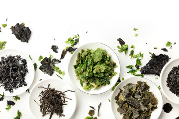 Various dry seaweed, sea vegetables, shot from the top on white. Superfoods background with a place for text © laplateresca