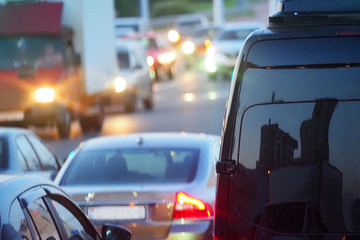 Evening, city traffic jams, city street road. Black van in the foreground