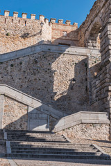 Partial view stairs attached to the aqueduct leading to the wall, located in the city of Segovia, Unesco World Heritage Site, Spain