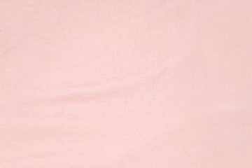Soft smooth pink silk fabric background. Fabric texture.
