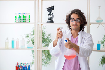 Funny male chemist working in the lab