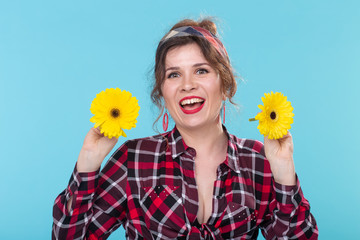 pin-up woman with two gerberas over the blue background