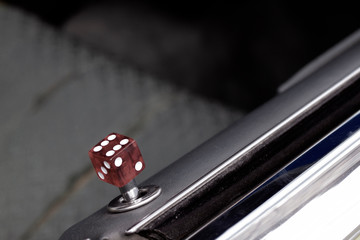Car door lock pin with dice in old classic car. Close up with space for text.