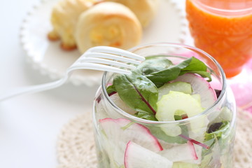 baby leaf salad in jar served with bread