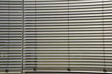 metal blinds outdoor as sun and sight protection, big outside blinds on house facade
