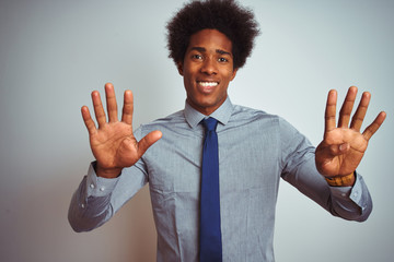 American business man with afro hair wearing shirt and tie over isolated white background showing...