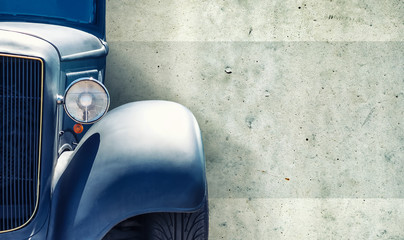 The headlight of the old beautiful car on the background of a concrete wall. Copy space. Concept banners repair, sale of cars.