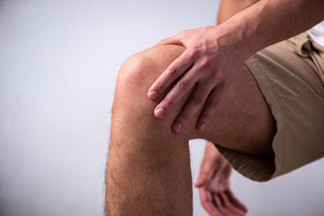 Young man suffering from leg pain