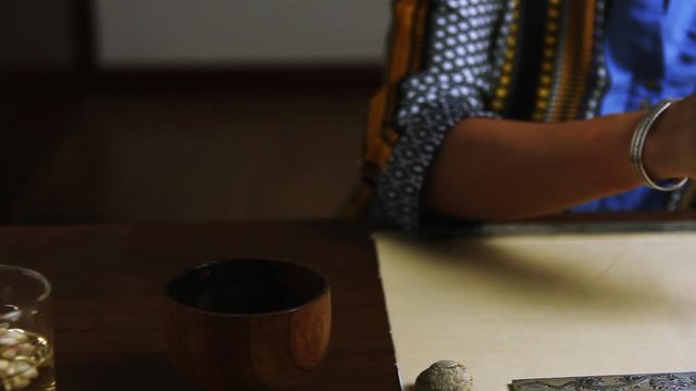 Girl writes Chinese characters (Translation from Chinese Mandarin 1: jixiang ruyi wanshi ankang- to be gratified propitiously with everything in good health, 2: fugui jixiang: wealthy and propitious)
