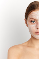 Facial mask on beautiful woman's face, closeup cropped portrait on female with perfect skin, spa, health and beauty treatment,copy space