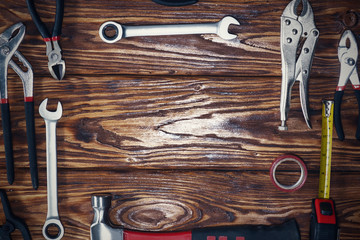 Close up tools on a wooden background.