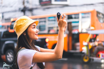 Asian traveler woman taking photo with instant camera