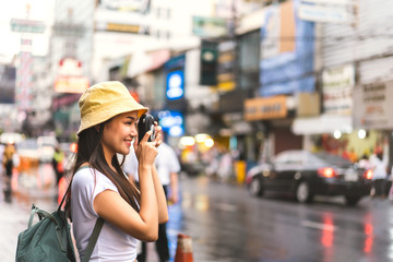 Fototapeta premium Asian traveler woman taking photo with instant camera