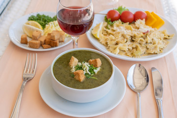 Green cream soup from spinach with croutons, cheese and fresh parsley