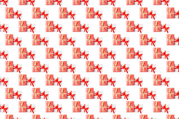 Pattern of christmas gift boxes with red and gold ribbons on white background. Flat lay design template.