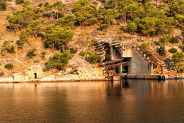 Submarine and ship bunker on Lastovo island, Croatia. Concrete bunker shelter for submarines in...