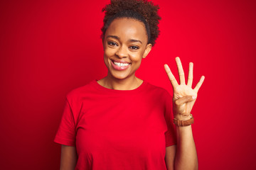 Young beautiful african american woman with afro hair over isolated red background showing and pointing up with fingers number four while smiling confident and happy.