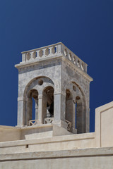 Fototapeta na wymiar Marble bell tower of Roman Catholic Cathedral, Naxos town, Greek Islands