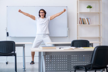 Fototapeta premium Young male student in front of whiteboard